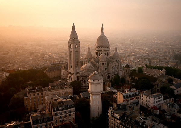 Paris’ Sacré-Cœur glowing in a hazy sunrise.