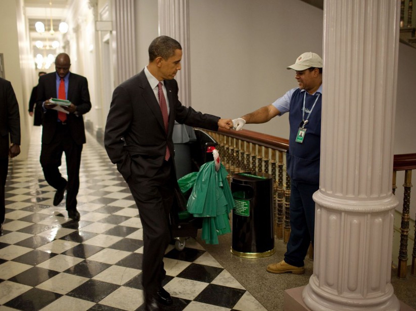 President Barack Obama fist-bumps custodian Lawrence Lipscomb in the Eisenhower Executive Office Building following the opening session of the White House Forum on Jobs and Economic Growth, Dec. 3, 2009. (Official White House Photo by Pete Souza) This official White House photograph is being made available only for publication by news organizations and/or for personal use printing by the subject(s) of the photograph. The photograph may not be manipulated in any way and may not be used in commercial or political materials, advertisements, emails, products, promotions that in any way suggests approval or endorsement of the President, the First Family, or the White House.