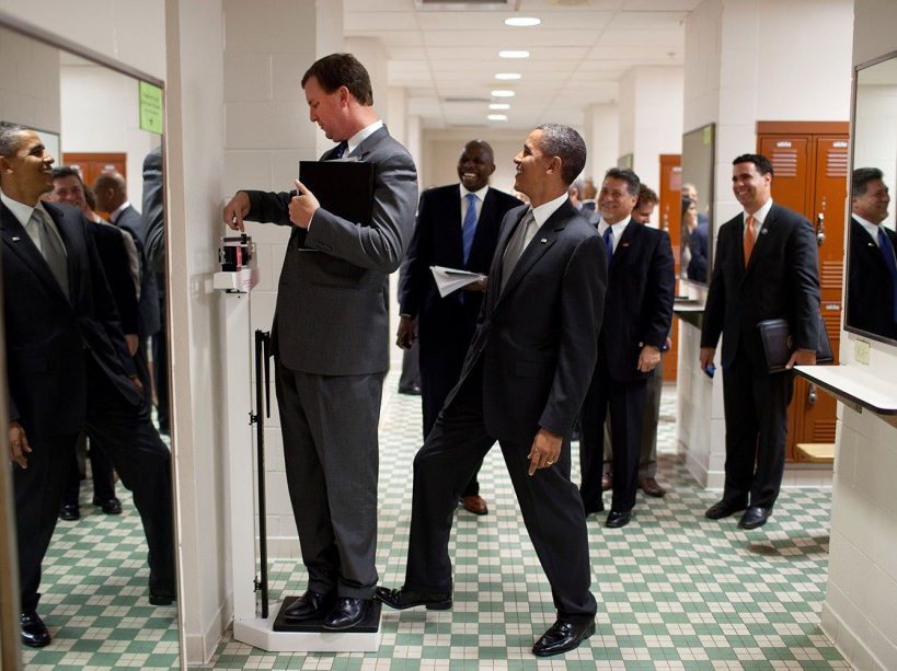 Aug. 8, 2010 "We were walking through a locker room at the University of Texas when White House Trip Director Marvin Nicholson stopped to weigh himself on a scale. Unbeknownst to him, the President was stepping on the back of the scale, as Marvin continued to slide the scale lever. Everyone but Marvin was in on the joke." (Official White House Photo by Pete Souza) This official White House photograph is being made available only for publication by news organizations and/or for personal use printing by the subject(s) of the photograph. The photograph may not be manipulated in any way and may not be used in commercial or political materials, advertisements, emails, products, promotions that in any way suggests approval or endorsement of the President, the First Family, or the White House.
